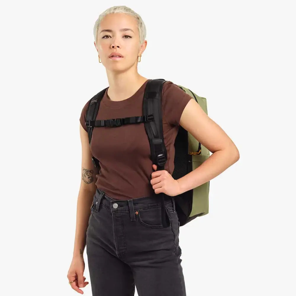 Ruckas Backpack 23L Oil Green. This 23L backpack is all about access. Easily get to your gear through the side or top with it's 3/4 length main zipper. Made from recycled materials. Stow the essentials, and be ready for the day.